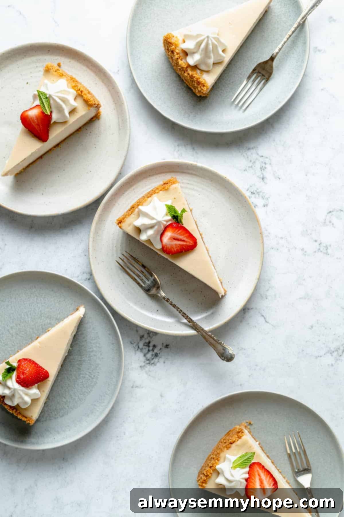 A beautiful vegan cheesecake adorned with fresh sliced strawberries on top, showcasing its creamy texture.