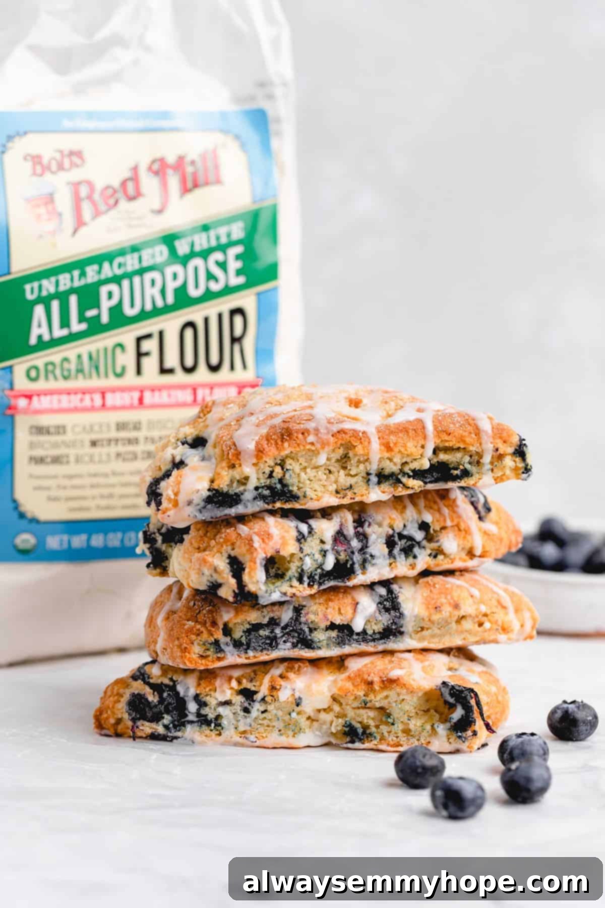 Fluffy Vegan Scones 15 Four stacked blueberry vegan scones with a bag of Bob's Red Mill flour in the background