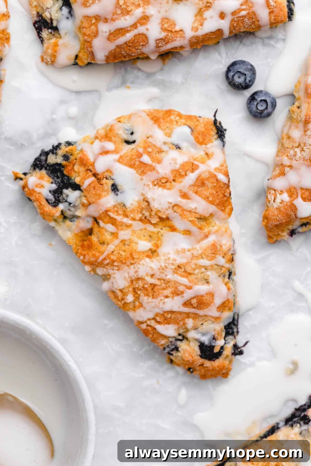 Fluffy Vegan Scones 16 Bird's eye view close-up of a glaze-drizzled vegan scone on a cooling rack