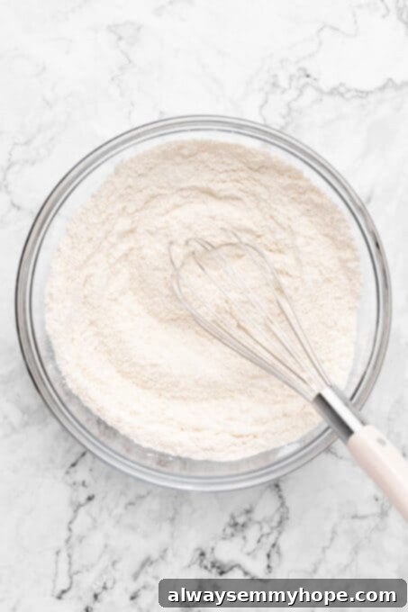 Fluffy Vegan Scones 5 Dry scone ingredients being whisked together in a glass bowl