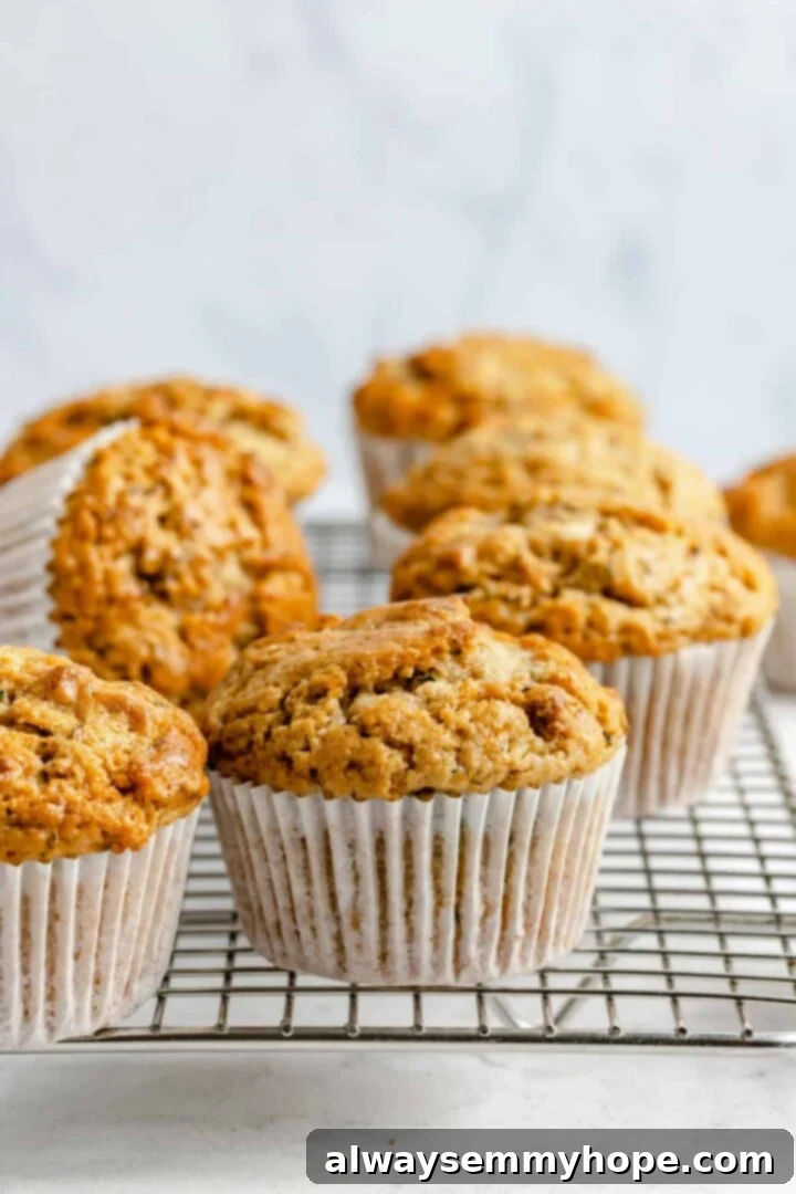 Garden-Fresh Vegan Zucchini Muffins 16 Freshly baked vegan zucchini muffins cooling on a wire rack.