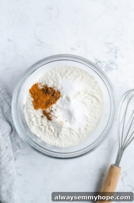 Flour, baking powder, and spices in a bowl.