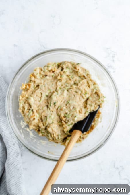Mixed zucchini bread batter in a bowl.