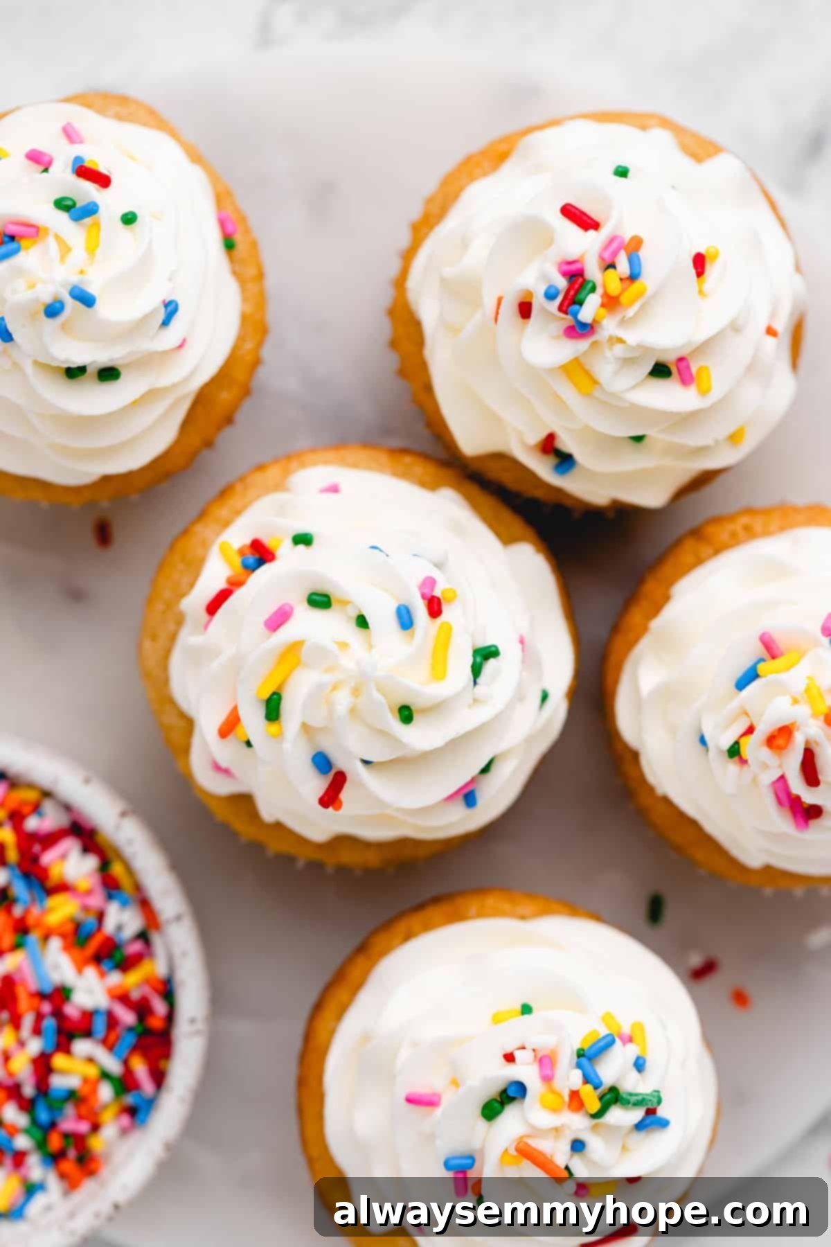 A row of frosted vegan vanilla cupcakes, showcasing their delightful appearance.