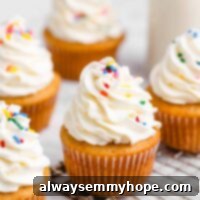 Vegan vanilla cupcakes with rainbow sprinkles.