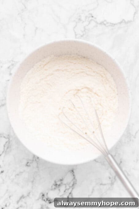 Bowl of dry ingredients for vanilla cupcakes, ready to be mixed.