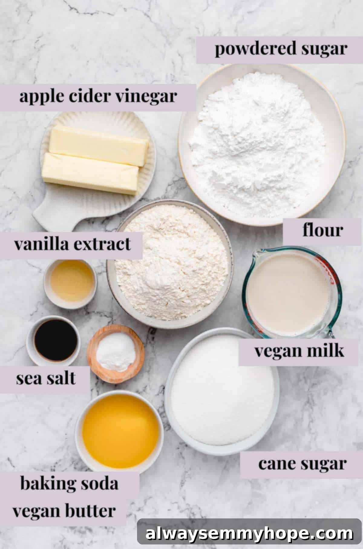 Various ingredients for vegan vanilla sheet cake laid out on a table, including flour, sugar, and vegan milk.