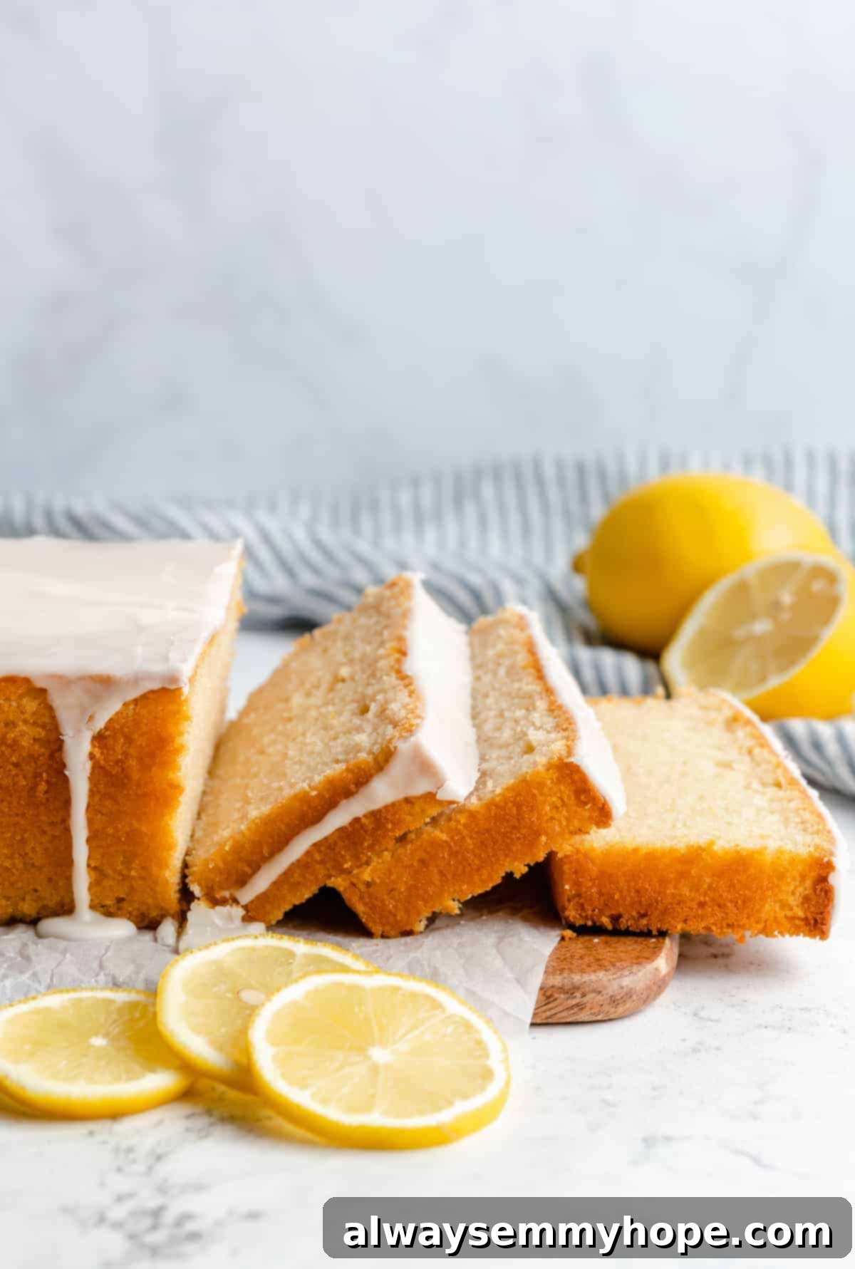 A beautifully sliced loaf of vegan lemon quick bread, showing its tender crumb and inviting texture.