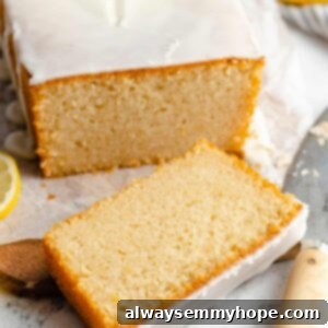 A slice of vegan lemon pound cake with a drizzle of glaze.