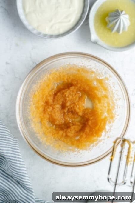 Thoroughly mixed wet ingredients for the lemon loaf cake, showing a slightly emulsified texture.