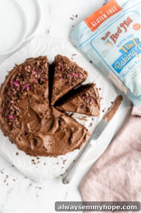 birds eye view of gluten free chocolate cake fully frosting and cut into slices