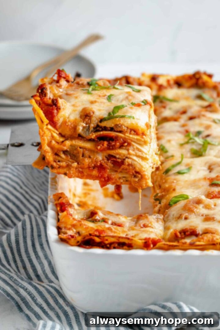 A generously portioned slice of cheesy vegan lasagna, showcasing its layers of rich sauce, pasta, and plant-based cheese, ready to be enjoyed. This hearty dish is a comfort food classic and a great source of protein for vegans.