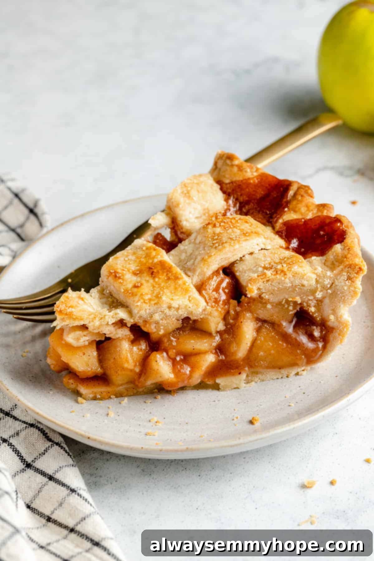 Perfect Vegan Apple Pie 17 A close-up shot of a single slice of vegan apple pie, showcasing the flaky crust and rich filling.