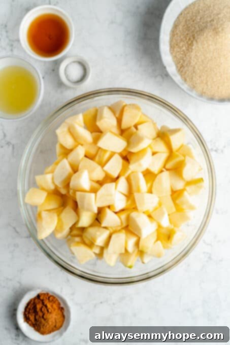 Perfect Vegan Apple Pie 6 Chopped apple pieces in a large mixing bowl, ready for seasoning.