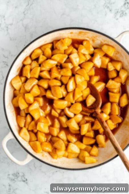 Perfect Vegan Apple Pie 9 Close-up of apples cooking with cinnamon, nutmeg, and butter, creating a delicious filling.