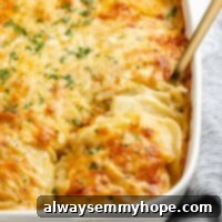 Creamy Vegan Potato Bake 2 Vegan scalloped potatoes in baking dish with spoon scooping out a serving