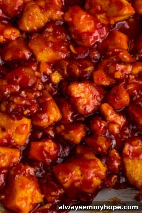 Korean Gochujang Tofu Rice Bowls 14 Close-up of crispy tofu bites completely coated in a rich, sticky gochujang sauce in a pan.