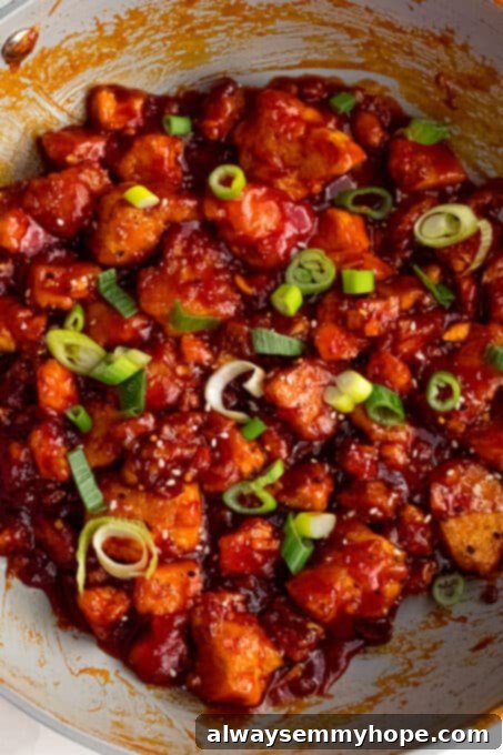 Korean Gochujang Tofu Rice Bowls 15 Prepared Korean Gochujang tofu, garnished with white sesame seeds and fresh green onions, ready for serving.