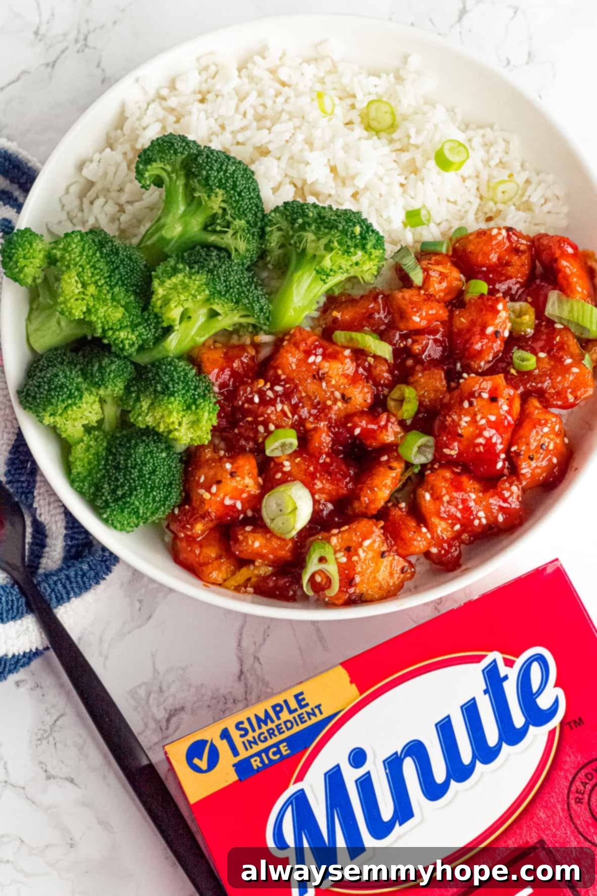 Korean Gochujang Tofu Rice Bowls 16 Two vibrant Korean Gochujang Tofu Rice Bowls, garnished with sesame seeds and green onions, with a box of Minute Rice in the background.