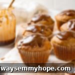 Glazed pumpkin banana muffins arranged appealingly on a wooden board, showcasing their golden tops and sticky glaze.