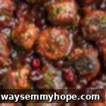 Overhead view of glossy, sweet and tangy vegan cranberry meatballs simmering in a pan, ready to be served.