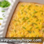 A golden-brown vegan corn casserole baked in a rustic baking dish, showcasing its creamy, comforting texture.
