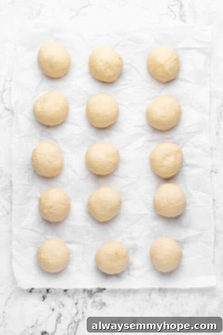 Evenly spaced dough balls arranged in a baking dish before their second rise.