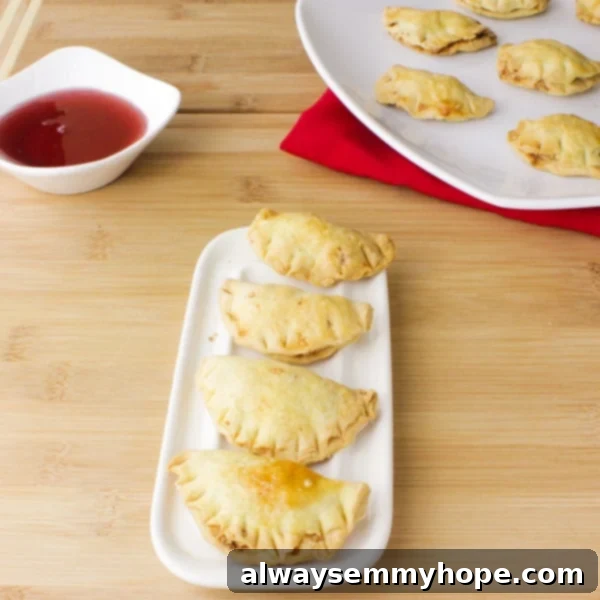 Delicious Gok Jai peanut puff cookies for Chinese New Year, arranged beautifully on a white dish, showcasing their golden, puffy texture.