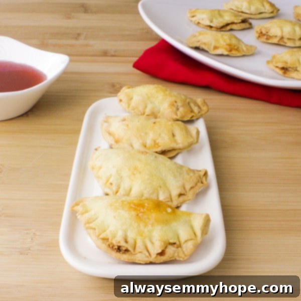 Close-up side view of golden-brown Gok Jai peanut puff cookies stacked on a white dish, highlighting their delicate layers and perfect puff.