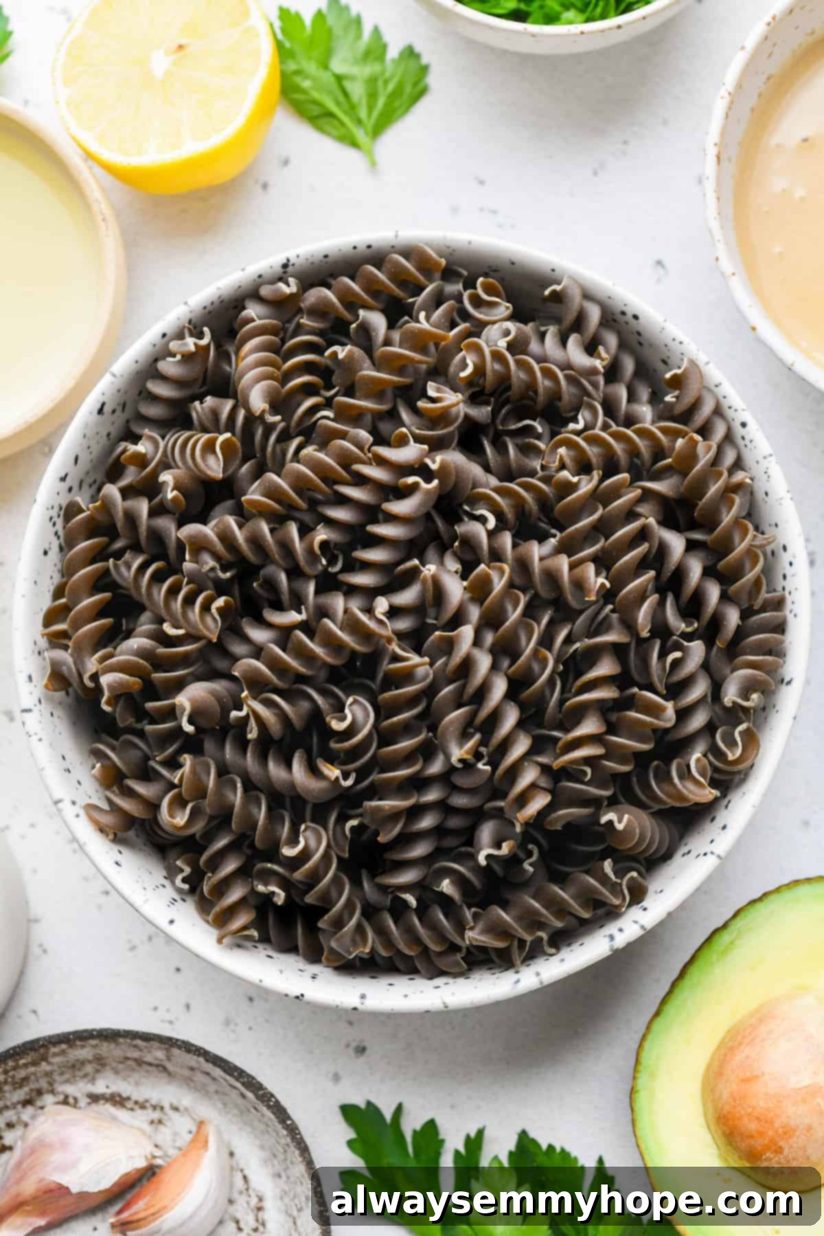 Divine Green Pasta 4 A bowl filled with raw, uncooked Green Lentil Pasta, ready to be boiled for the Green Goddess Pasta recipe.