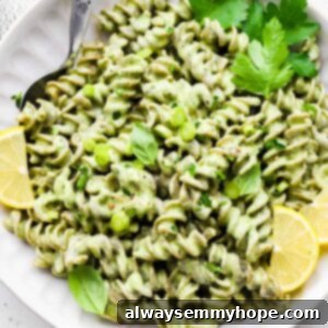 Divine Green Pasta 10 A bowl of homemade green goddess pasta with lemon wedges and fresh parsley on top.