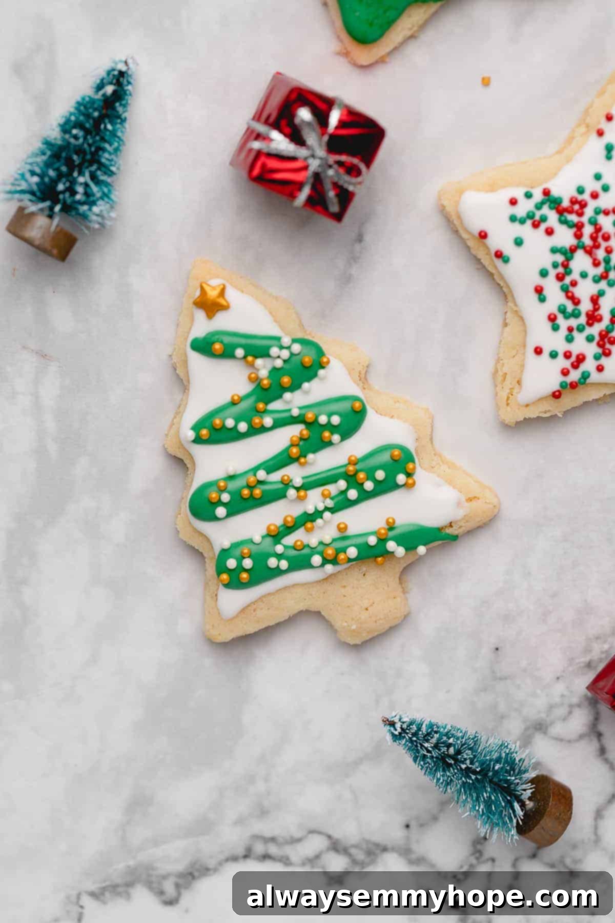 Closeup of Christmas tree cutout sugar cookie with frosting and sprinkles