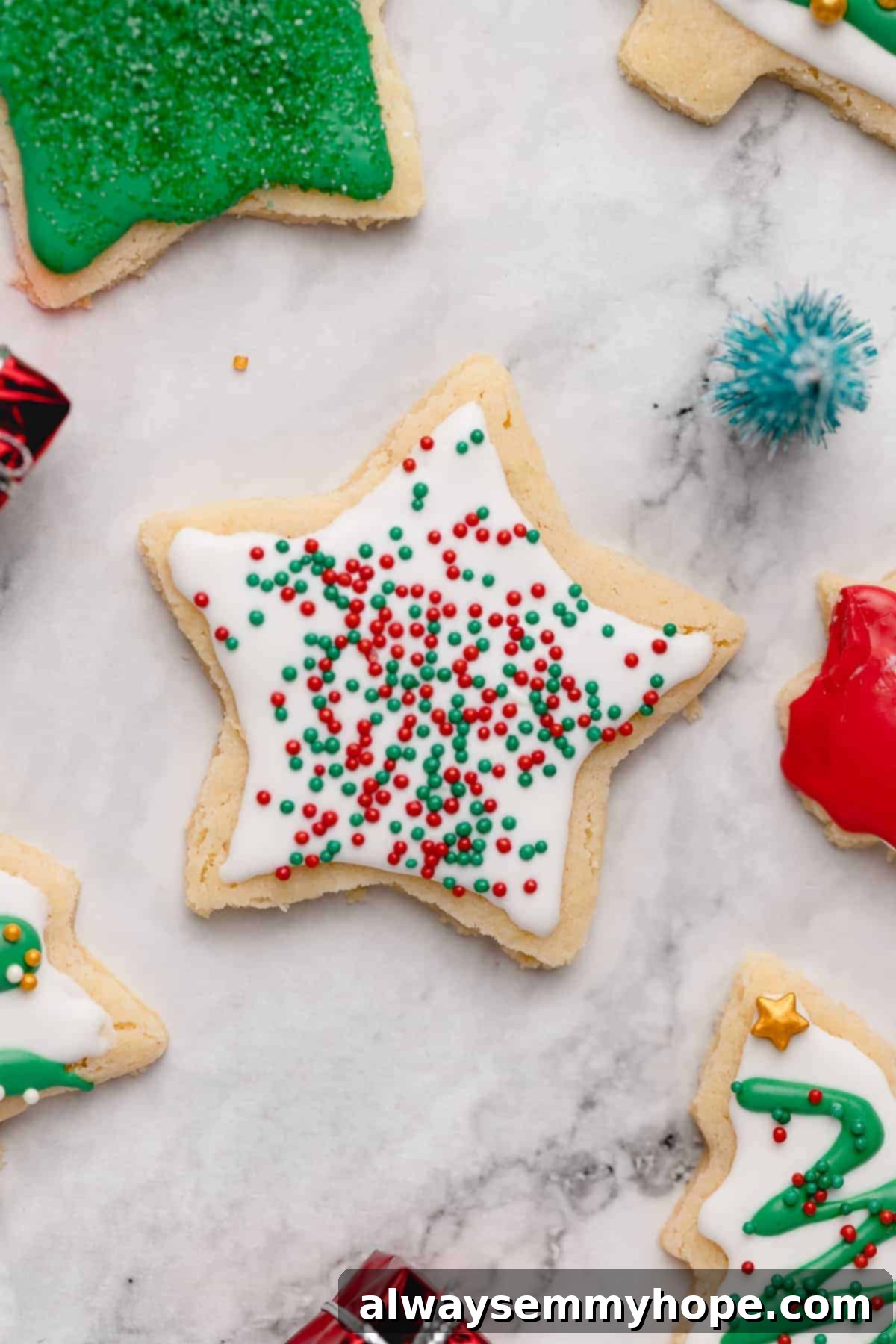 Closeup of star sugar cookie decorated with white frosting and sprinkles