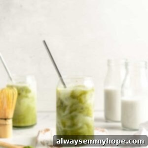 Smooth Iced Matcha Latte 16 Iced matcha latte in glass tumbler with stainless steel straw