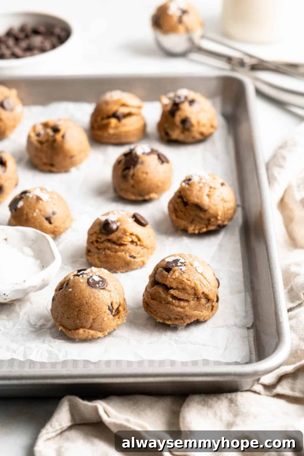 Edible chocolate chip cookie dough on parchment lined baking sheet