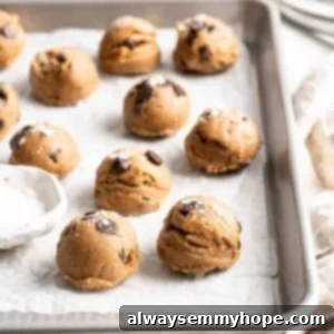 Edible chocolate chip cookie dough on parchment lined baking sheet