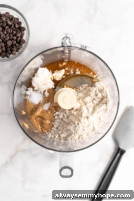 Overhead view of edible cookie dough ingredients in food processor