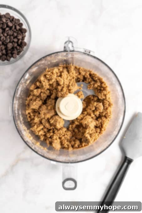 Overhead view of edible cookie dough in food processor