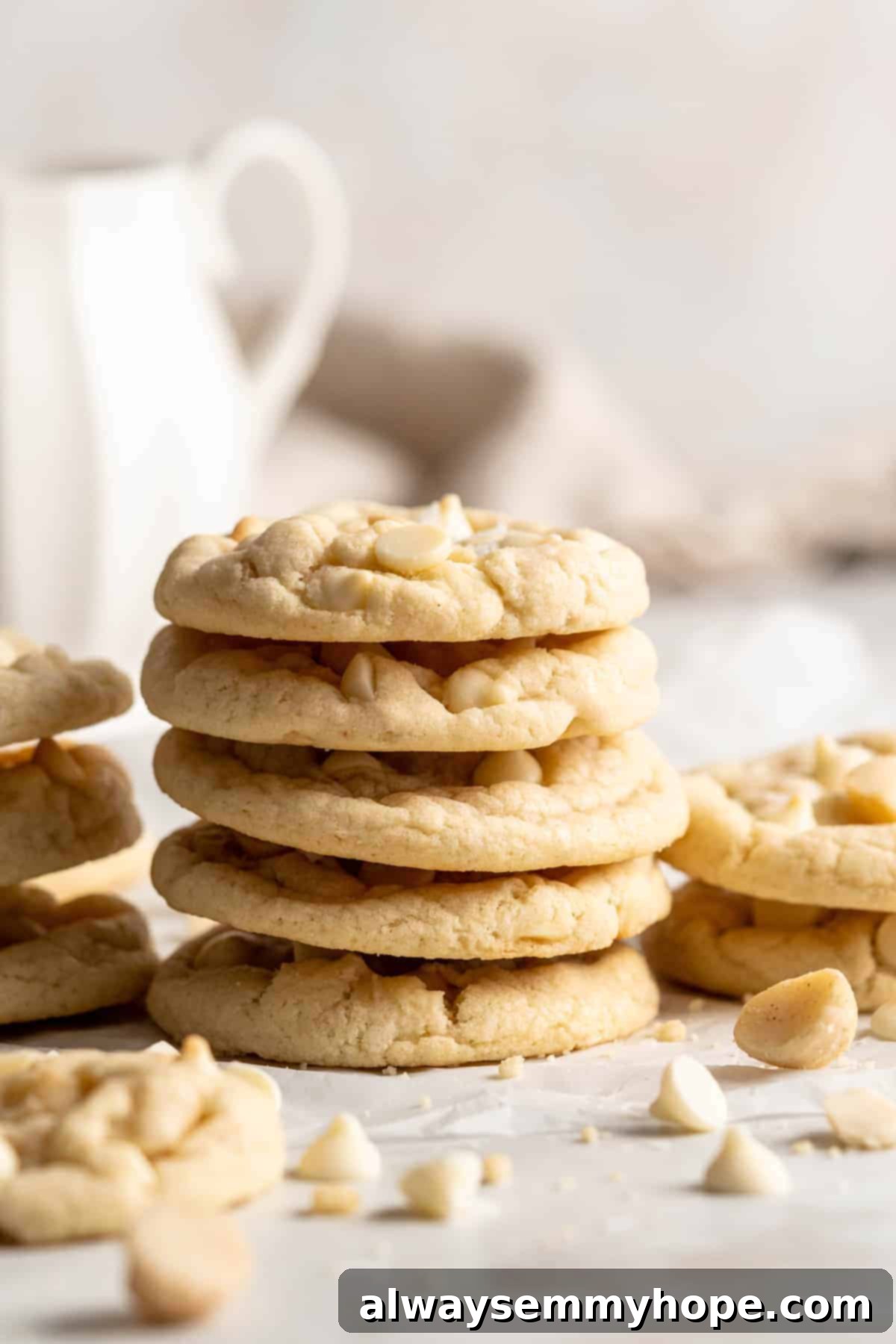 Delicious stacks of vegan white chocolate macadamia nut cookies. Neatly stacked vegan white chocolate macadamia nut cookies on a kitchen countertop, ready to be enjoyed.