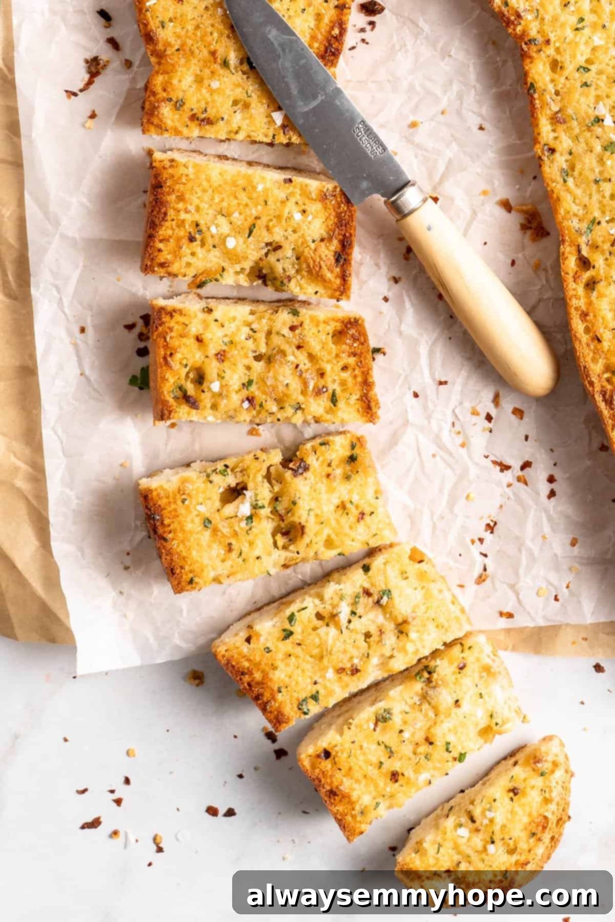 Garlic bread sliced into pieces with a knife, ready to serve and enjoy