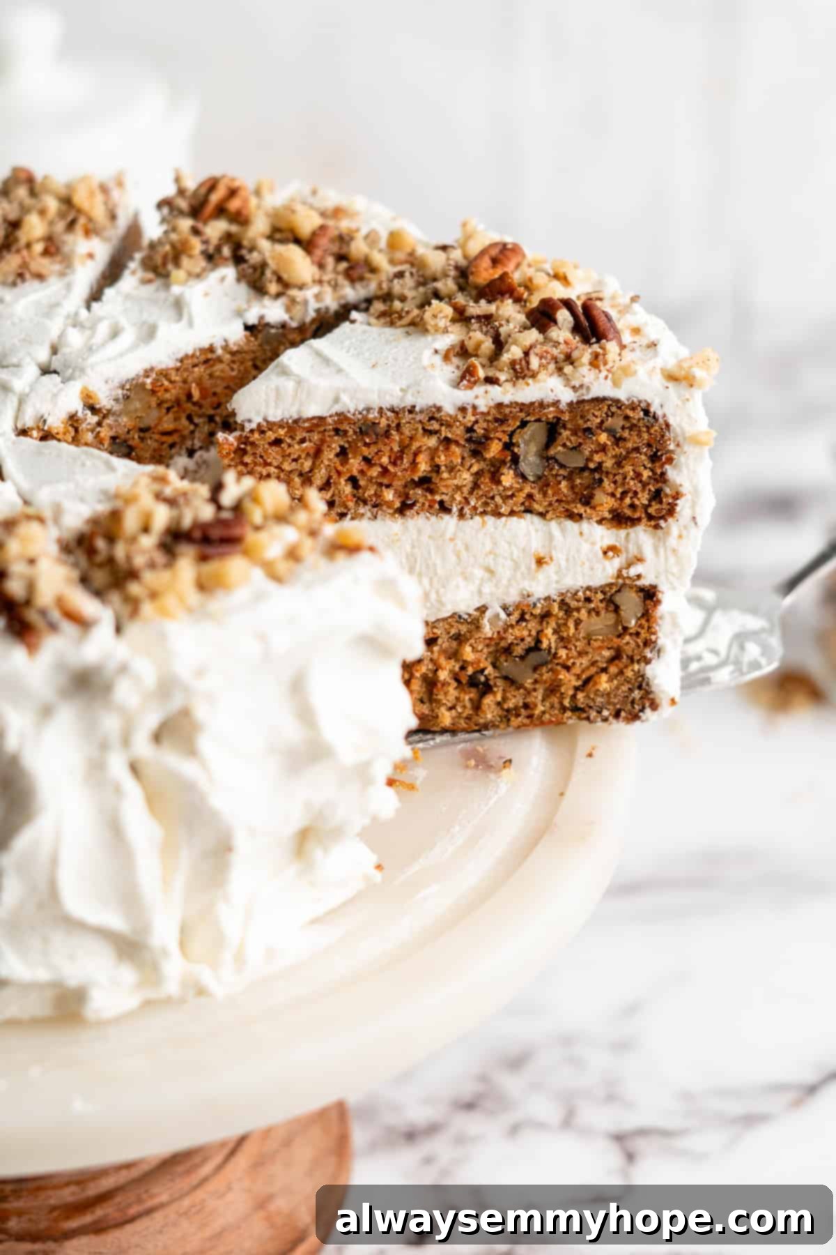 Decadent Plant-Based Carrot Cake 15 Slice of vegan carrot cake being removed from cake