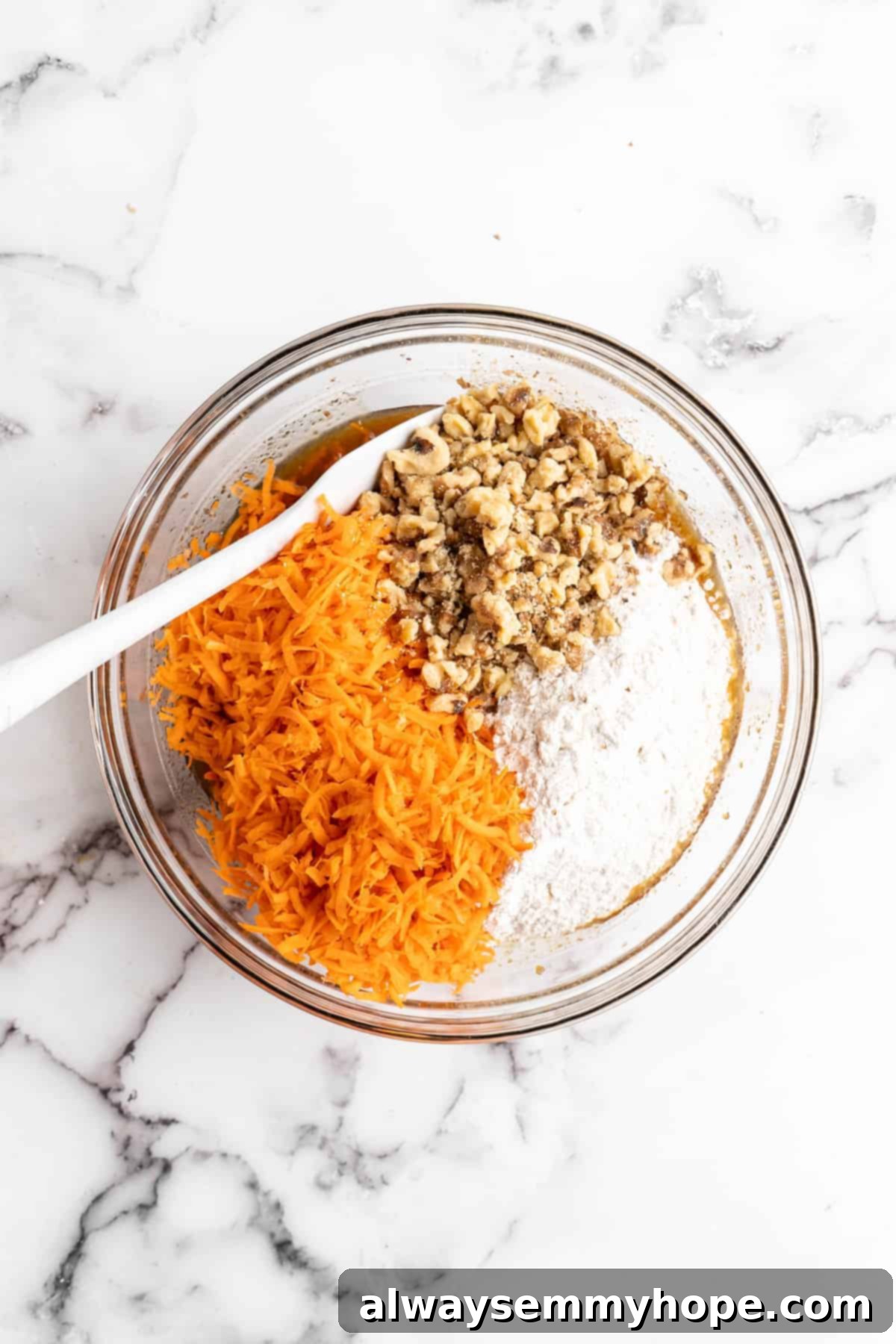 Decadent Plant-Based Carrot Cake 8 Overhead view of vegan carrot cake ingredients in glass mixing bowl