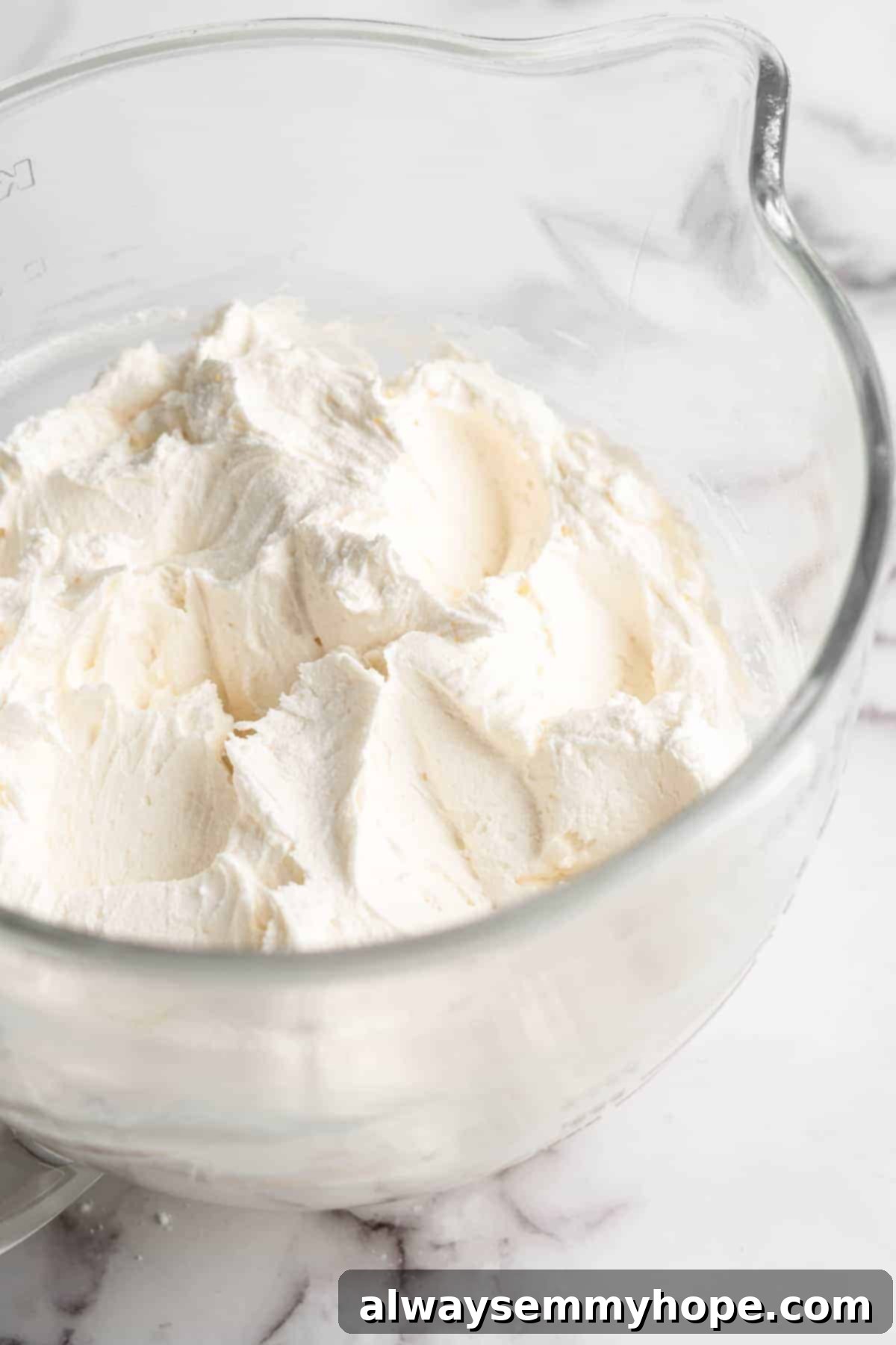 Vegan cream cheese frosting in glass mixing bowl