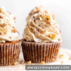 Closeup of vegan carrot cupcake with cream cheese frosting on cake stand