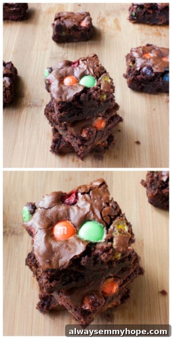 Double Chocolate M&M Brownies are probably one of my favourite brownie recipes! The M&Ms add so much texture and extra chocolate flavour. Homemade chocolate treats on a wooden table.