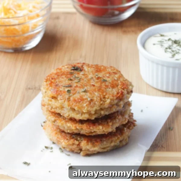 Three perfectly formed, uncooked Sun-dried Tomato and Mozzarella Quinoa Veggie Burger patties resting on a textured linen napkin, ready for cooking. The vibrant red of sun-dried tomatoes is visible within the quinoa mix.