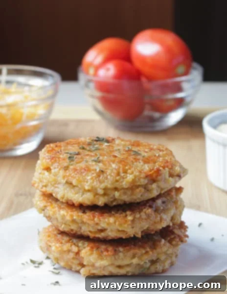 A tempting side shot of a single Sun-dried Tomato and Mozzarella Quinoa Veggie Burger, perfectly cooked and placed on a wooden table, showing its robust texture and colorful ingredients.