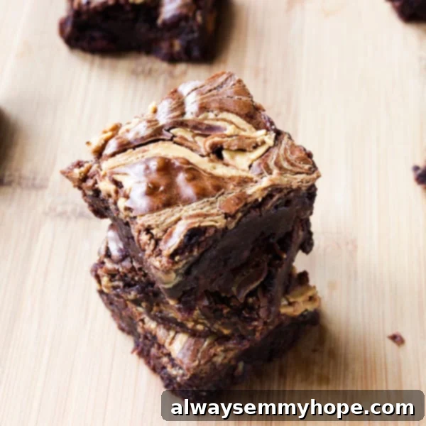 Perfectly Stacked Peanut Butter Swirl Brownies Stack of rich, fudgy peanut butter swirl brownies artfully arranged on a rustic wooden table, ready to be enjoyed.