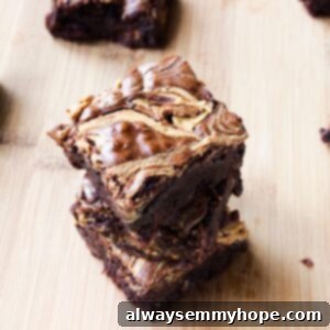 Chewy Fudgy Peanut Butter Swirl Brownies 2 Close-up of a stack of peanut butter swirl brownies, showing the rich texture and distinct peanut butter marbling.