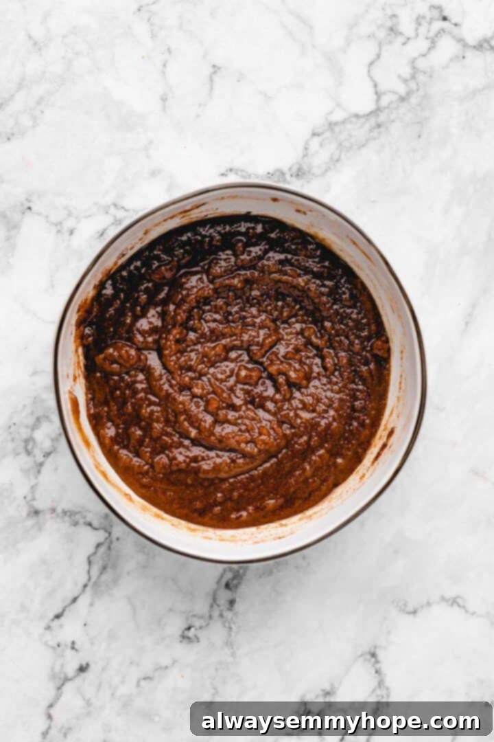 Overhead view of the fully mixed cinnamon filling in a mixing bowl, ready to be spread.